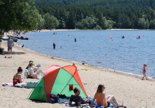 Sun bathers and children enjoy the waters and sandy beach of Loch Morligh in Strathspey in the shadow of Cairngorm. Picture by Sandy McCook