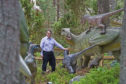 Dr Neil ‘Jurassic’ Clark, Curator of Palaeontology at University of Glasgow, officially opened the colossal gates to Dinosaur Kingdom at Landmark Adventure Park Carrbridge. Picture by Sandy McCook