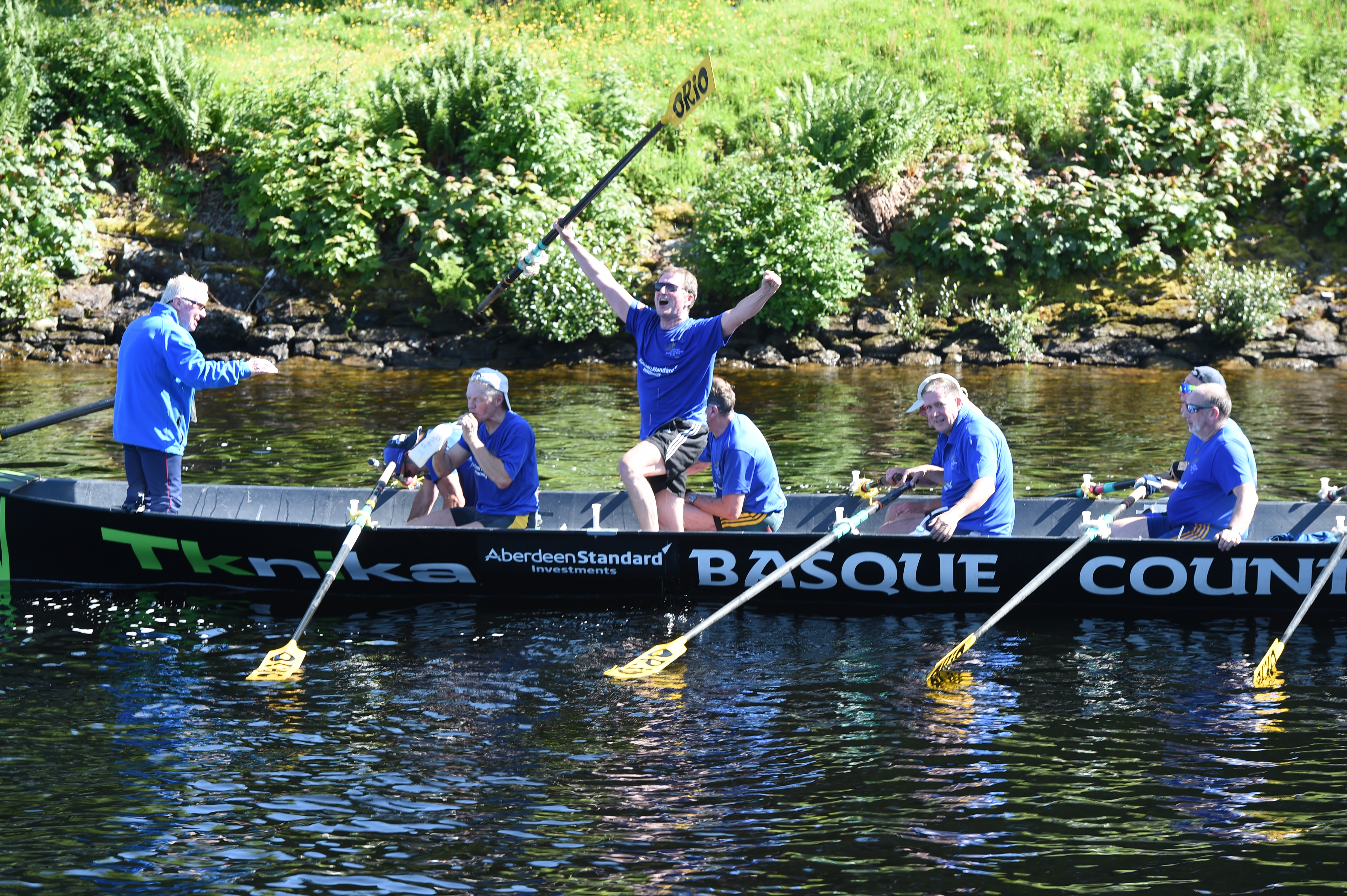 Delight as the crew of the safety boat relay back to the band of hardy rowers that their efforts have set a new record time for navigating Loch Ness in a rowing boat. Picture by Sandy McCook