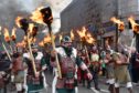 THE VIKINGS TORCH-LIT PARADE MARCHES THROUGH THE STREETS OF PORTSOY