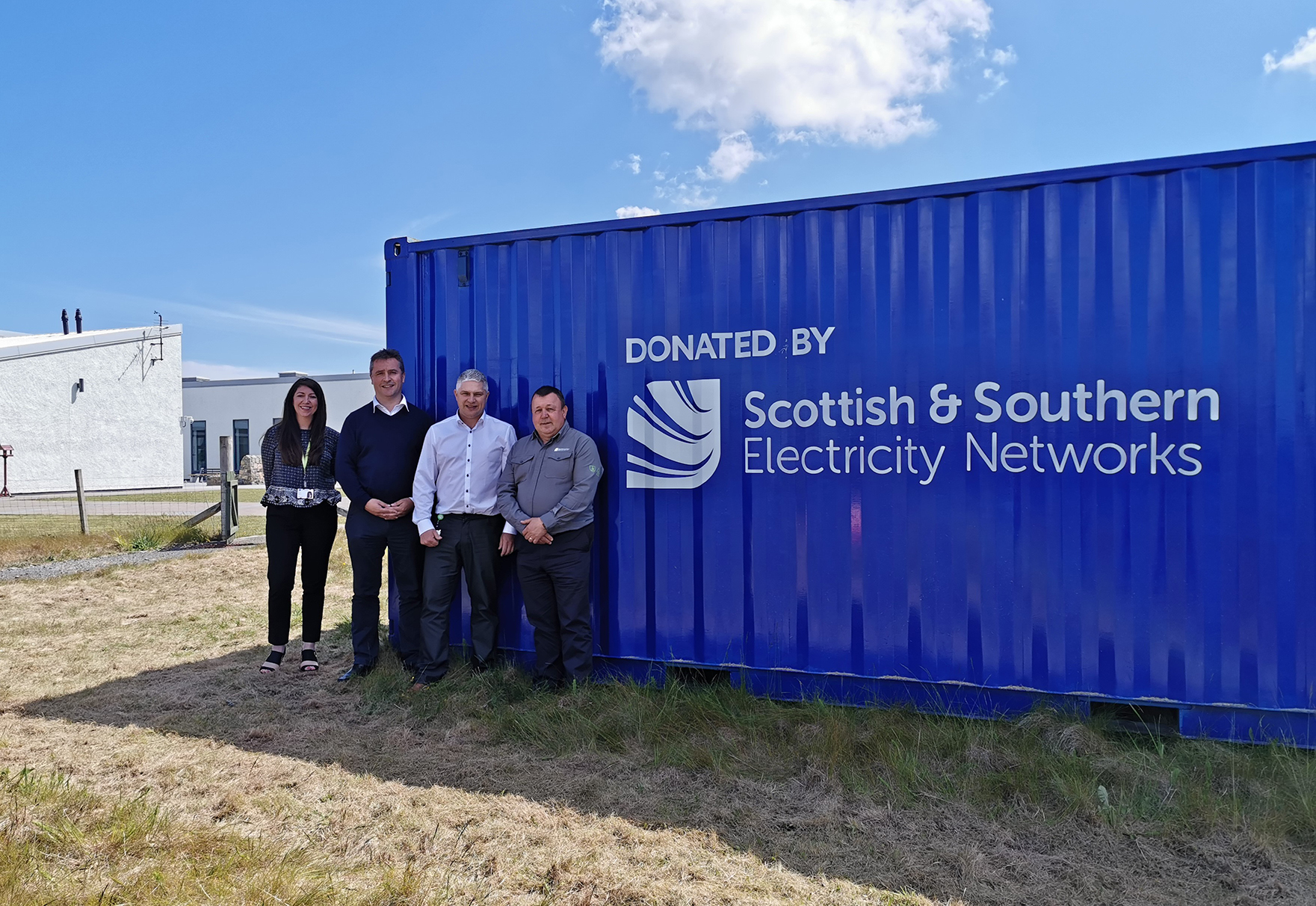Pamela Harvey, Angus Brendan MacNeil, Paul Schofield and CJ MacPhe at the container donated to the kayaking club.