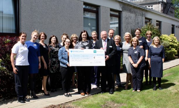 Hospital staff gift a £5,620 cheque.