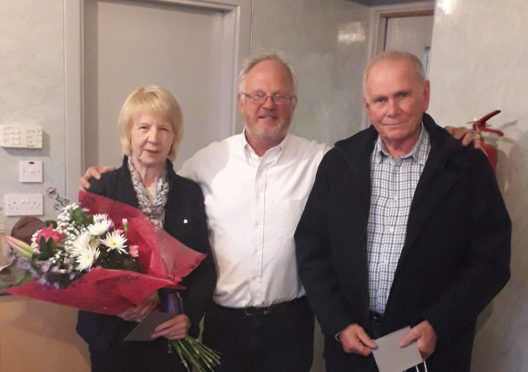 Community council chairman Bill Pitt between retiring members Barbara Anderson and Gordon Davidson