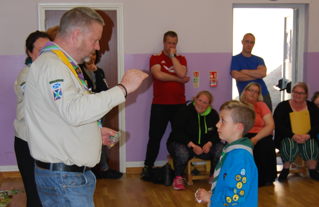 Ethan Brooks receives his special Three Peaks badge from the Scout's regional commissioner for the north-east of Scotland, Dougie Simmers.