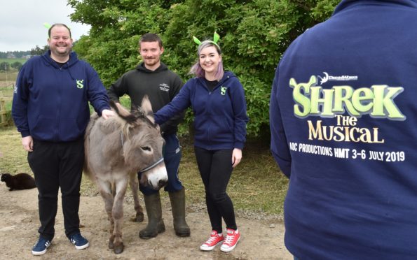 The cast of Shrek visited Willows and met Eeyore the donkey. Pictured (from left) is Scott Jamieson (Shrek), Michael Brown, animal husbandary and Hannah Smith (Sugar Plum Fairy)