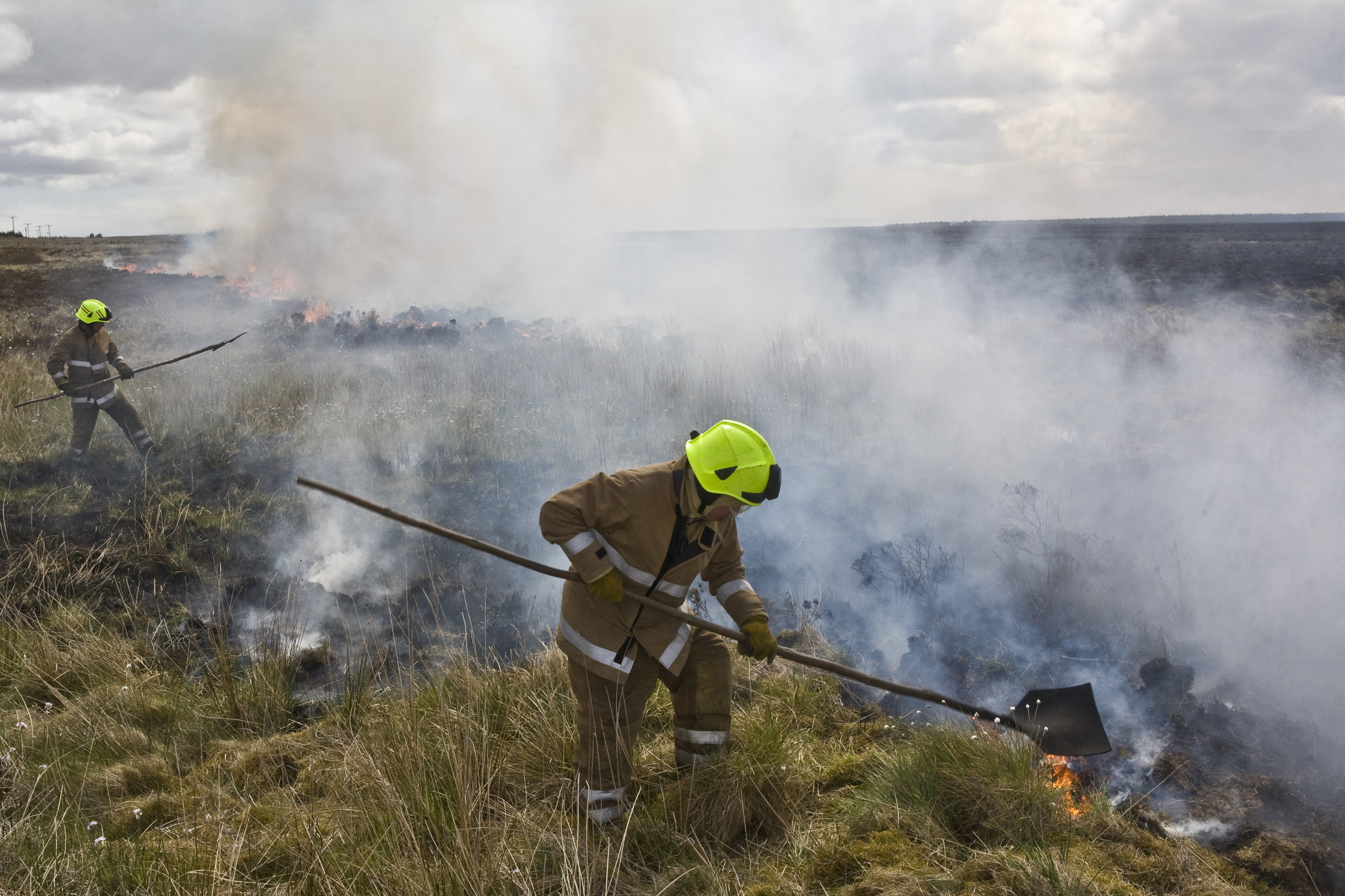 Firefighters tackles the wildfire which spread over a large area of deep peat at Killimster Moss.