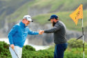 PORTRUSH, NORTHERN IRELAND - JULY 18: Andrew Johnston of England high fives Robert MacIntyre of Scotland on the 5th green during the first round of the 148th Open Championship held on the Dunluce Links at Royal Portrush Golf Club on July 18, 2019 in Portrush, United Kingdom. (Photo by Mike Ehrmann/Getty Images)