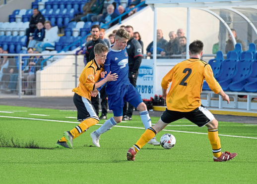 Fort William's John Treasurer (L) and Scott Hunter (R) with Cove's Hamish McLeod (centre).