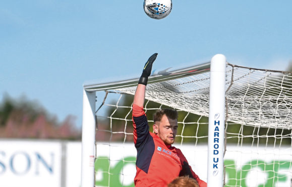 Turriff keeper Fraser Hobday clears a corner .
Pic by Chris Sumner