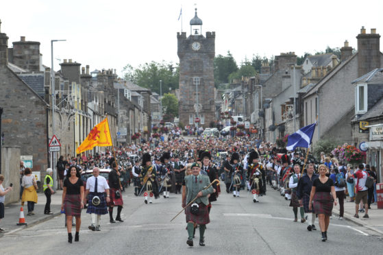 Chieftain Alex Grant marches with his three daughters.