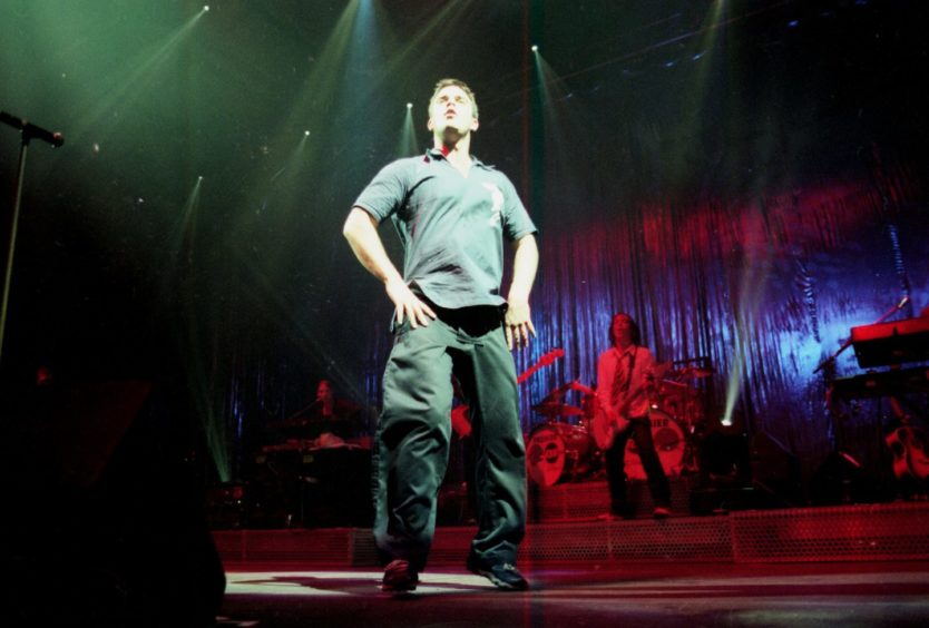 Robbie Williams performing at the AECC. in February 1999.

Negative ref. number 061180.