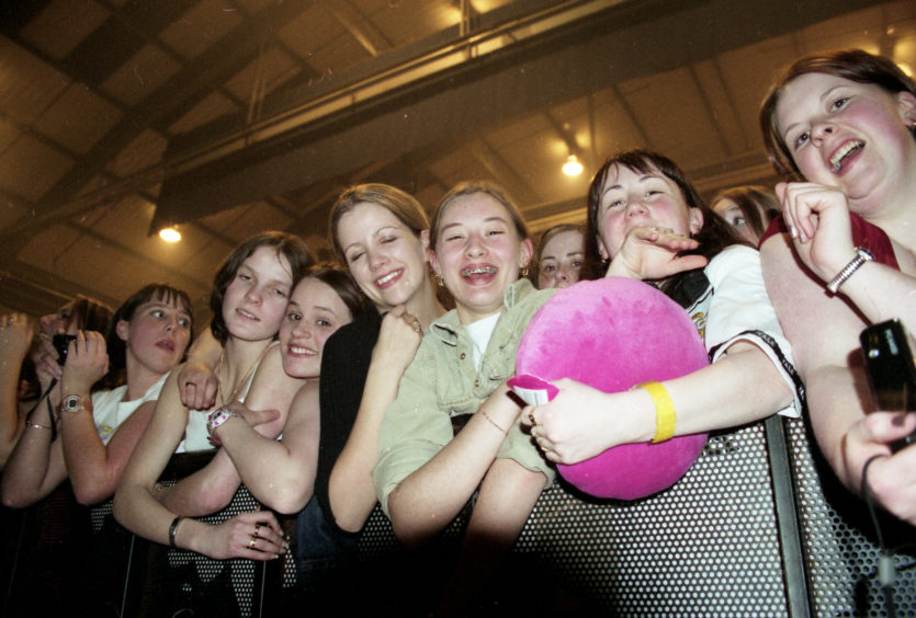 Fans watching Robbie Williams perform at the AECC in February 1999.
