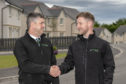 Zander Sutherland, right, is congratulated on his new award by assistant site manager George Johnstone.