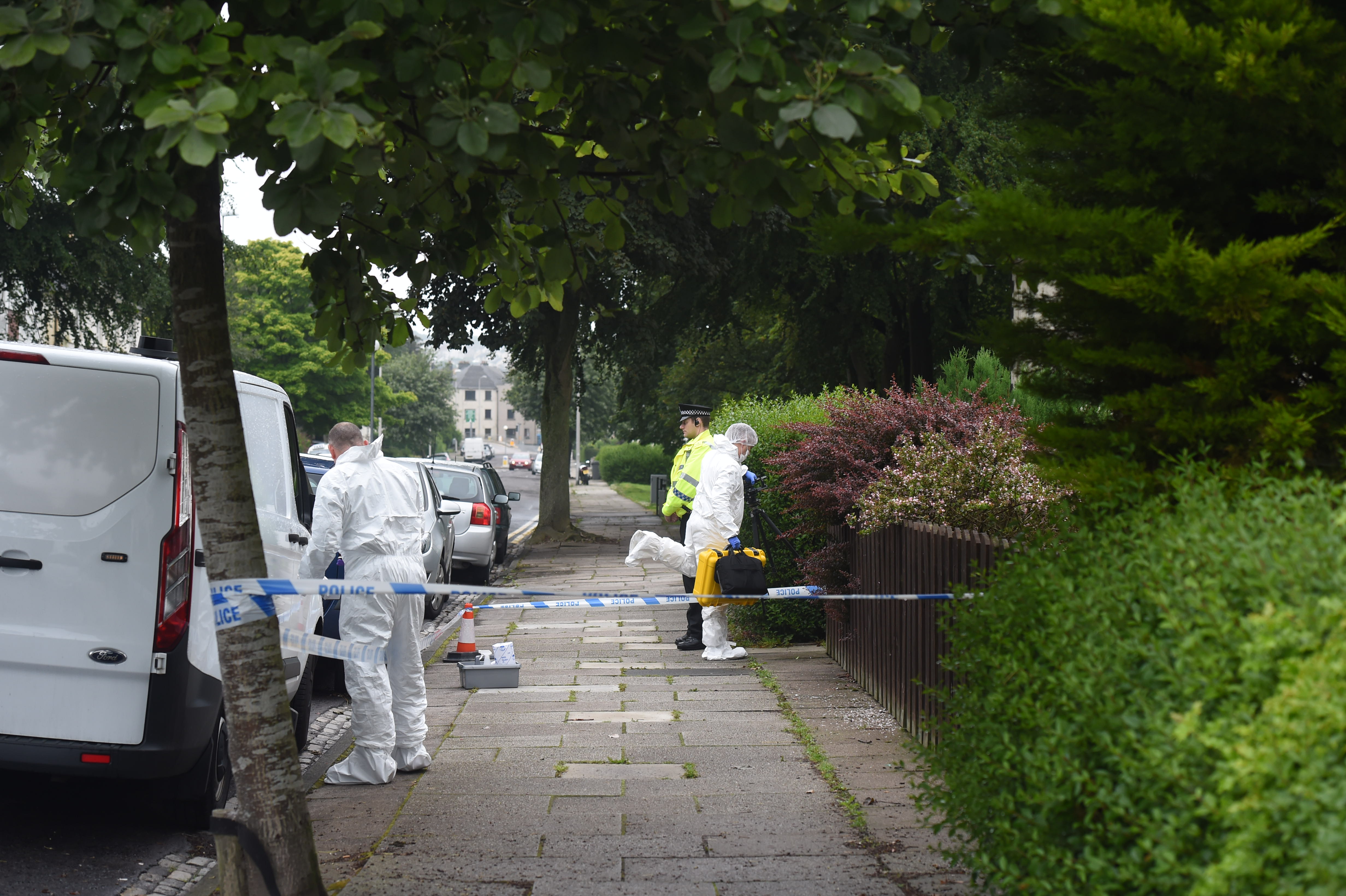 Police and forensics officers at the property in Clifton Road, Aberdeen. Photograph by Heather Fowlie