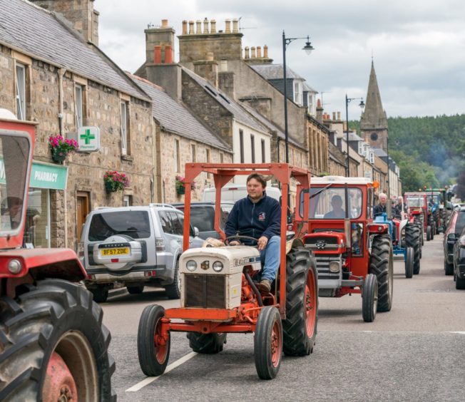 21 July 2019. Fochabers Square, Moray, Scotland, UK. This is a scene from Sundays activities within Fochabers Village during the Gala. Picture Content:- The Tractor Parade arrives in the Square.