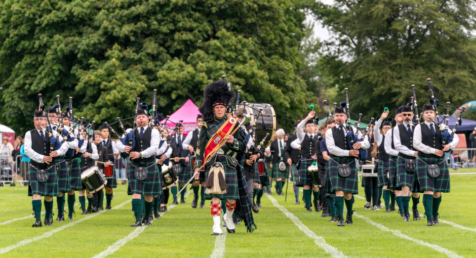Forres and District Pipe Band enter the arena to commence the games.