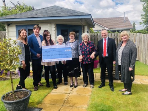 Representatives from Leys Group donate to the Forget Me Not Club