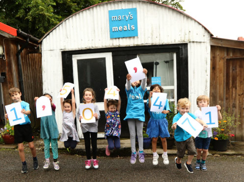 Local children at the shed in Dalmally where the charity was founded celebrate Mary’s Meals feeding 1.5 million children. photo:Kevin McGlynn