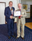 Ken Wilson receives his Paul Harris Award from outgoing President James Campbell