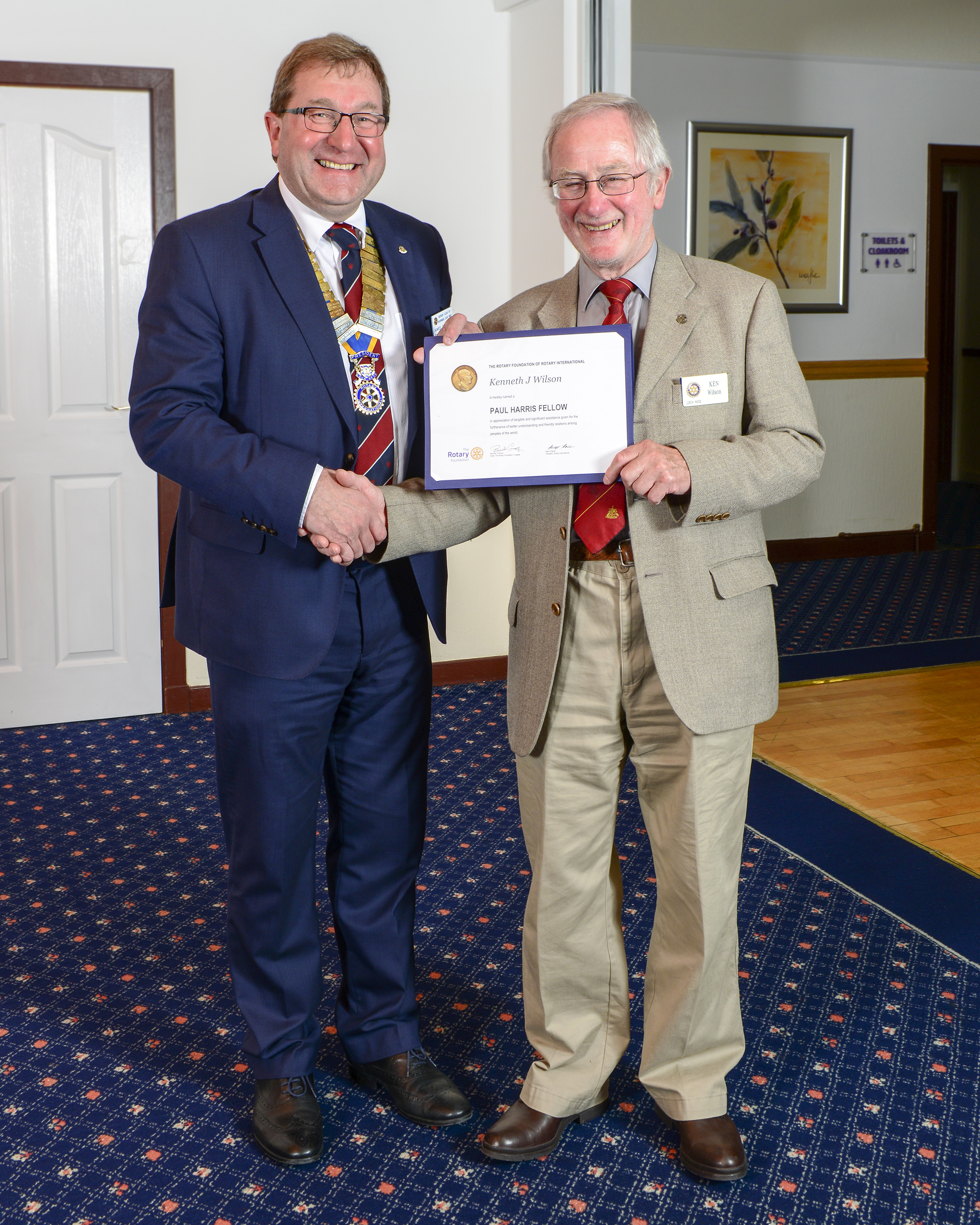 Ken Wilson receives his Paul Harris Award from outgoing President James Campbell