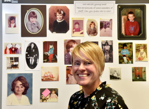 Lochpots deputy head Heather Milne with a collection of photographs of staff when they were in school.