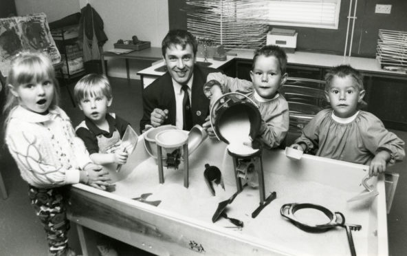 Councillor Brian Topping joins pupils (from left) Stacey McBride, John Downie and twin brothers John and Jason Jappy at the sandpit." From August 1992