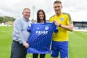 Prime Seafoods managing director George Forman and his daughter Naomi Charles present Peterhead FC captain Rory McAllister with the new home shirt.