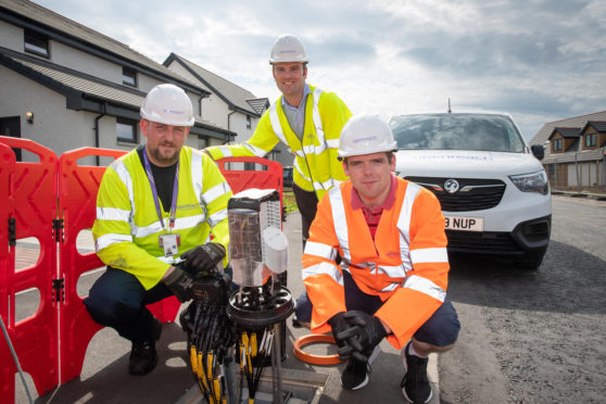 Openreach engineer Will MacGillivray and programme manager Ben Dempster show Moray MP Douglas Ross some of the new full fibre broadband hardware on a new housing estate in Buckie.