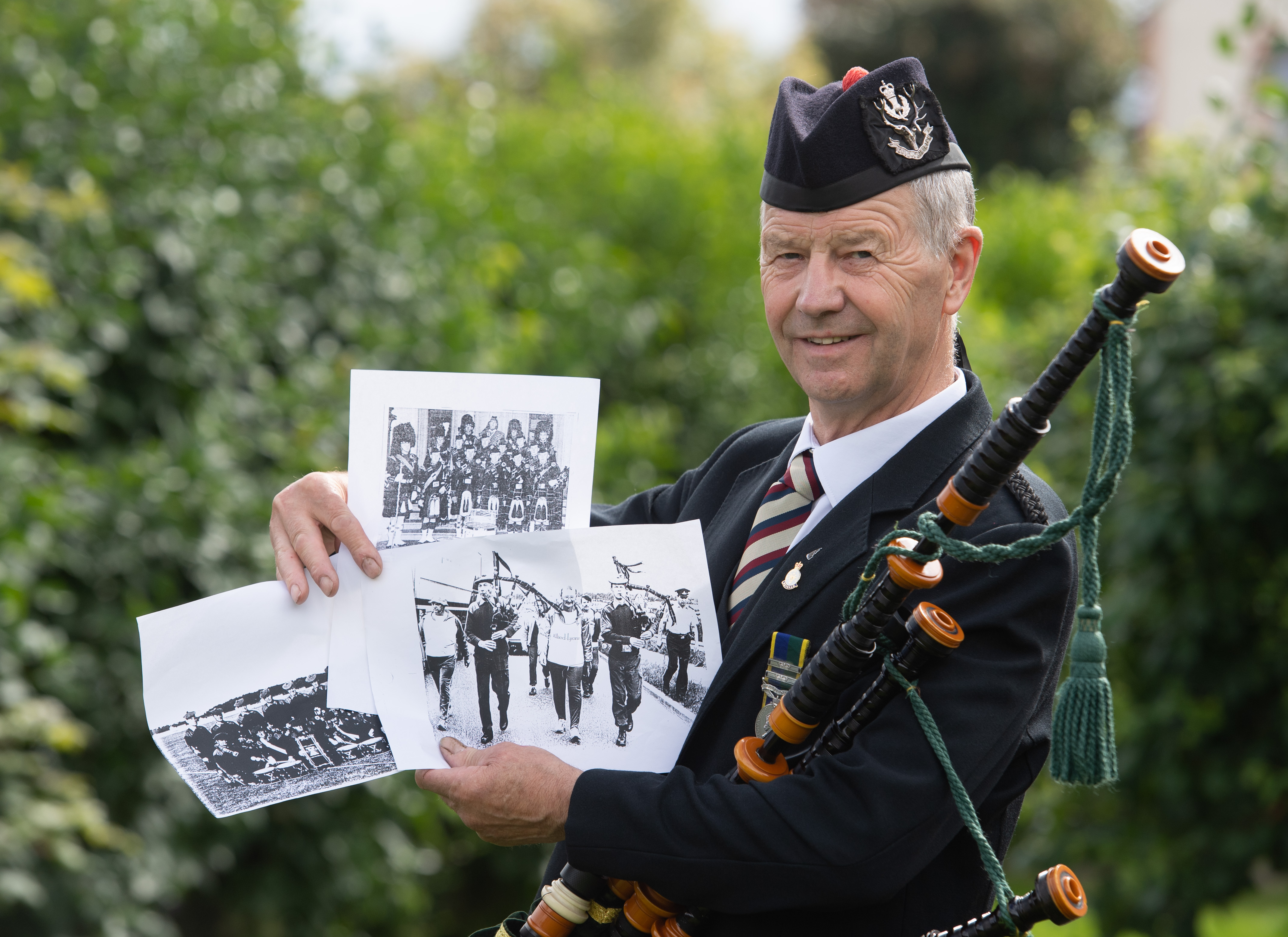 Gordon Duncan with photographs showing memories of his 26-year career with the Territorial Army.