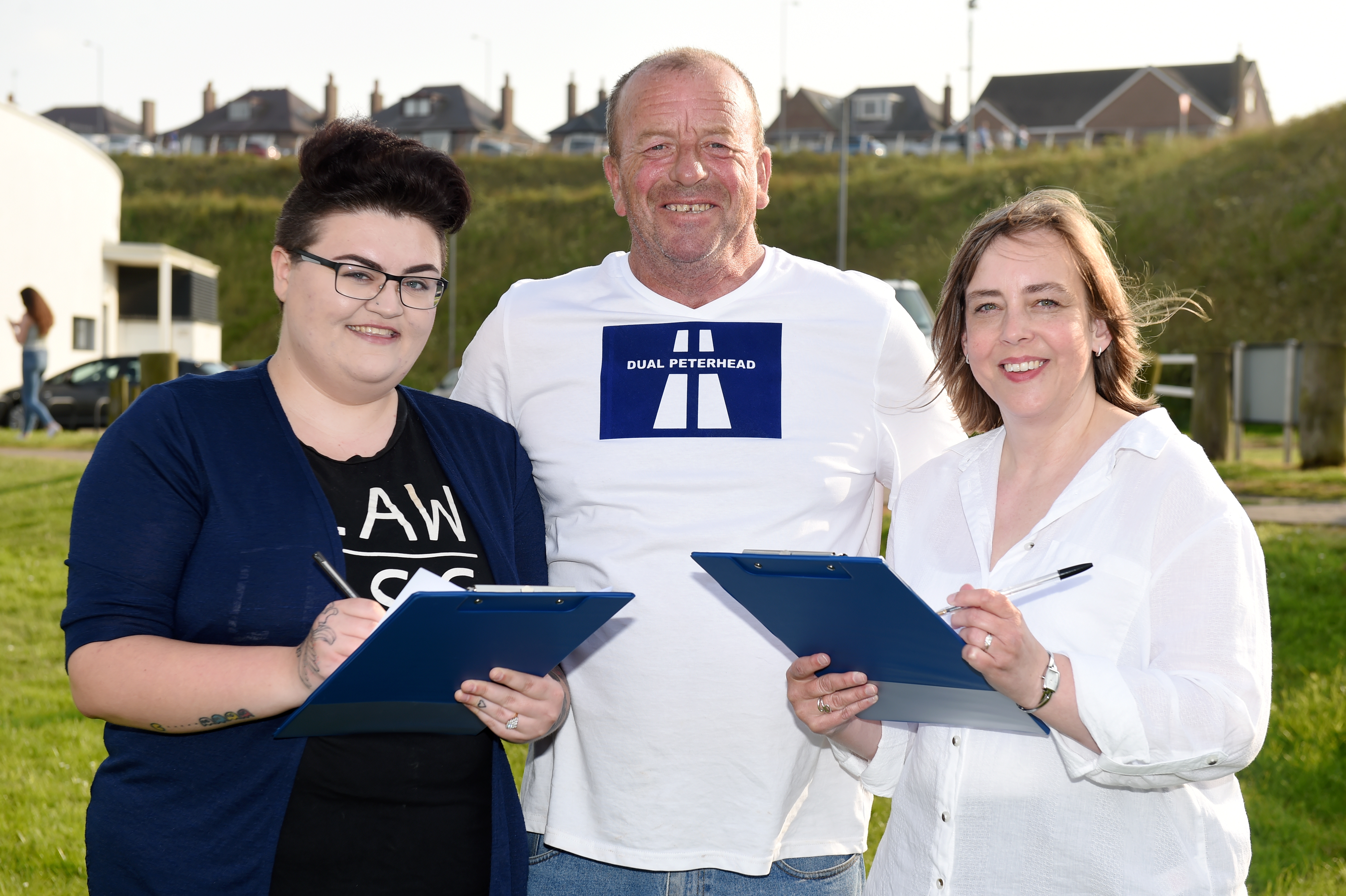 Dual Peterhead group asking for signatures.
Picture of (L-R) Sianan Watson, Bruce Buchan and Lisa Buchan.