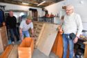 Ian Thomson (L), Len Steel and David Innes working in the cramped conditions at the Fraserburgh Men Shed.