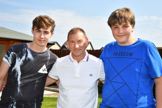 BROTHERS WULLIE (R) AND ALEX CRAWFORD, WHO GOT INTO DIFFICULTIES IN THE SEA AT THE BROCH MEET ONE OF THEIR RESCUERS CHAY CLARK.