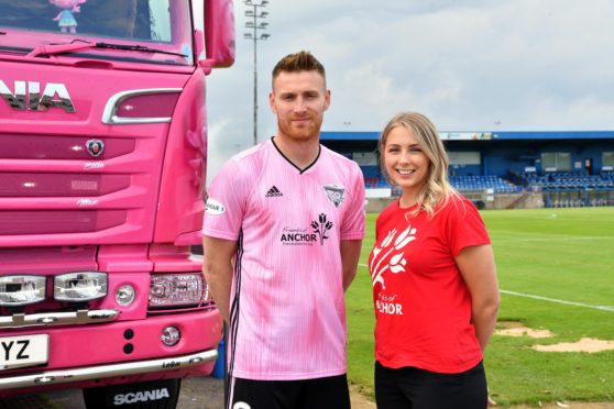 Peterhead forward Rory McAllister alongside Friends of Anchor's Erica Banks.