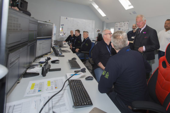 Prince Charles chats with marine co-ordinator Colin Brown and Gordon Morrison in the Beatrice Offshore Windfarm control room at Wick Harbour.