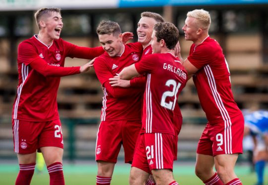 Lewis Ferguson celebrates with his teammates after making it 2-1 to Aberdeen.