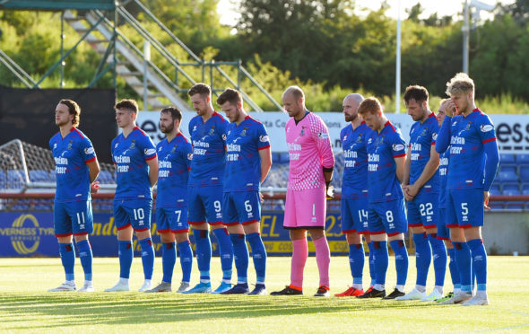 The Inverness players observe a minutes silence for former youth team coach, John Beaton