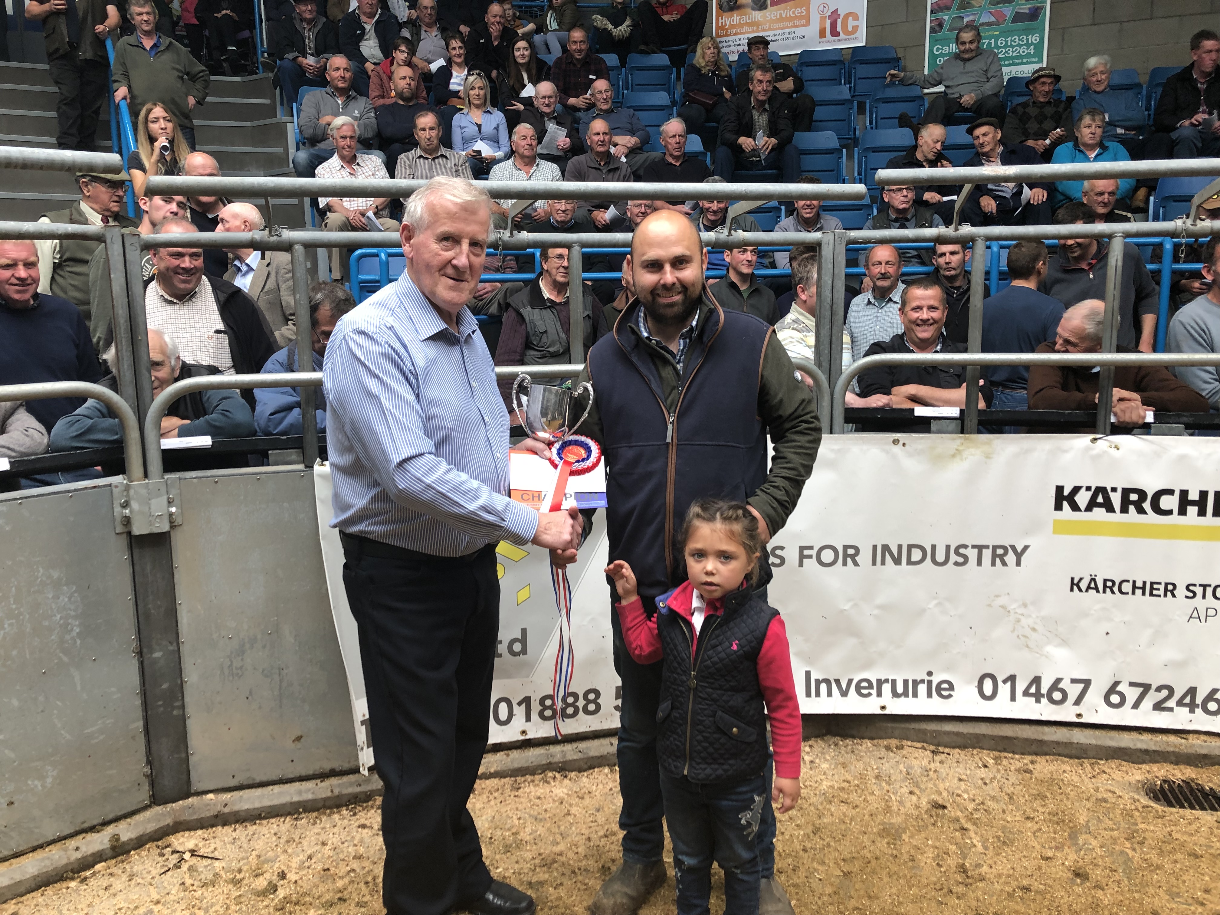 Steven Smith and daughter Lily with George Mearns, left, from Turriff Agri Parts.