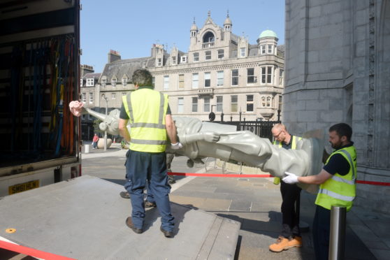 Pictured is artwork being loaded into a van at Marischal College, Broad Street, Aberdeen. The artwork is to be taken to the Aberdeen Art Gallery.
Picture by DARRELL BENNS   26/07/2019