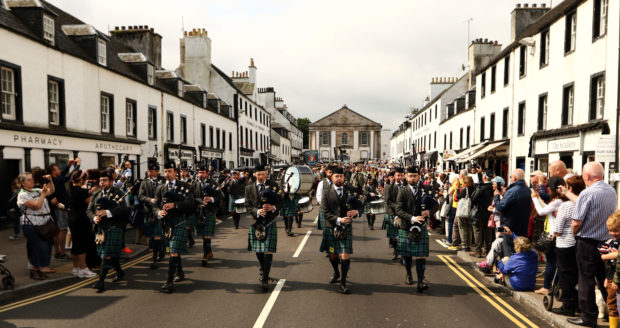 Inveraray and District Pipeband European Champions lead the parade down the main street to the games field.