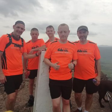 Cameron Mackintosh, Gary Ewen, Peter Duggie, John Norman and John Mccruden on top of Ben Rinnes.