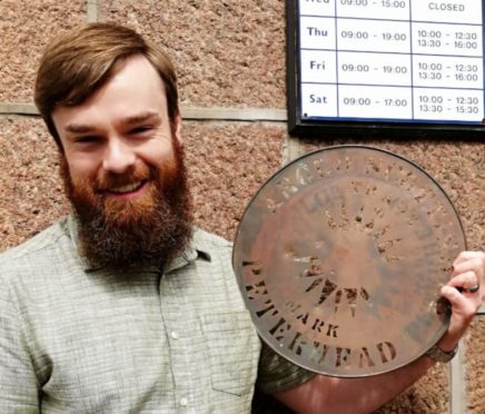 Antique dealer Robert Cook is hoping for some local antique objects such as this early 1900s herring barrel stencil