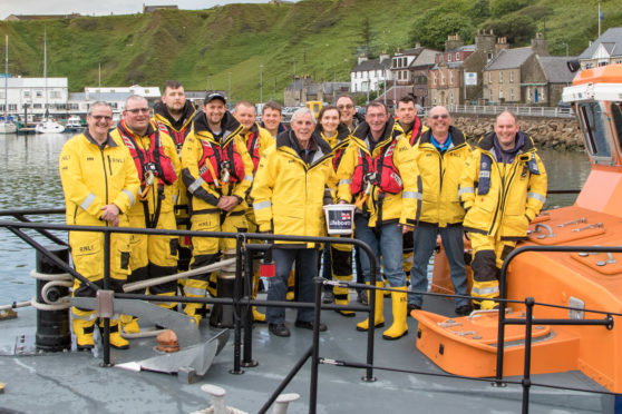 80-year-old Alexander Main presenting £750 to Thurso Lifeboat.