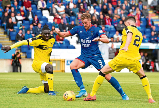 Inverness' Jordan White slips past Raith Rovers' Michael Miller and Fernandy Mendy