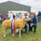 SUPREME SHEEP: The interbreed sheep champion was a home-bred Charollais gimmer, held by Keith Thomson, from Sheena Coghill, pictured on the right.