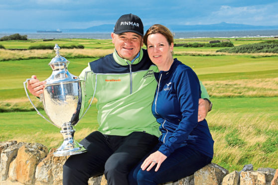 Paul Lawrie of Scotland and his wife Marian pose for a photograph after winning the Scottish Senior Open played at Craigielaw Golf Club.