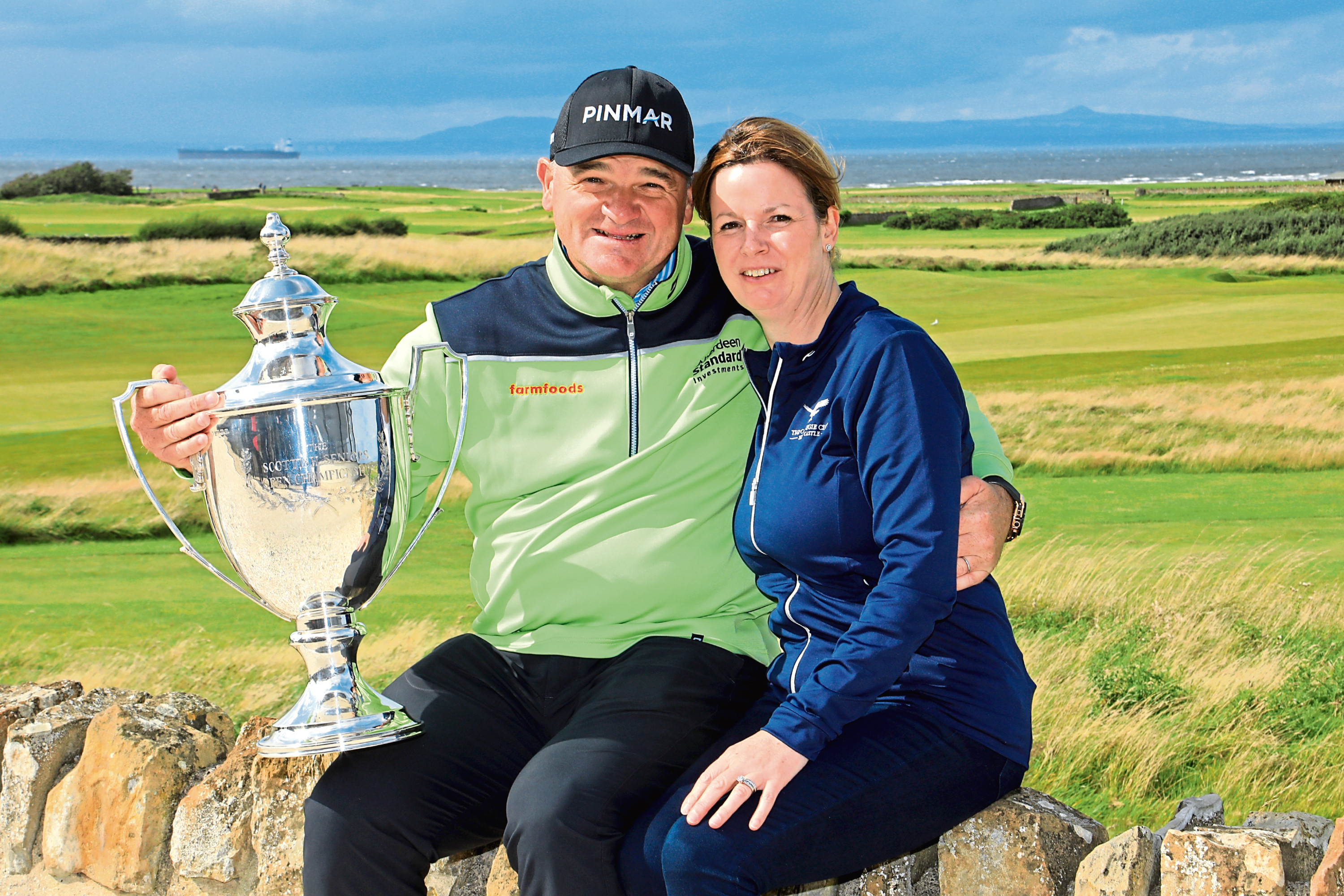 Paul Lawrie of Scotland and his wife Marian pose for a photograph after winning the Scottish Senior Open played at Craigielaw Golf Club.