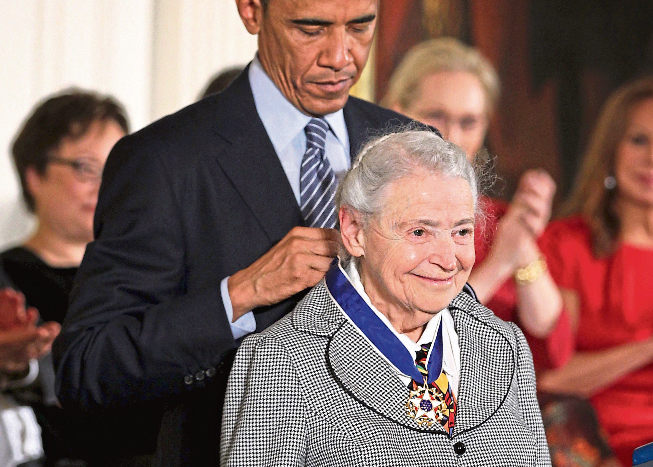 President Barack Obama (L) presents the Presidential Medal of Freedom to physicist Mildred Dresselhaus (R) during an East Room ceremony at the White House November 24, 2014