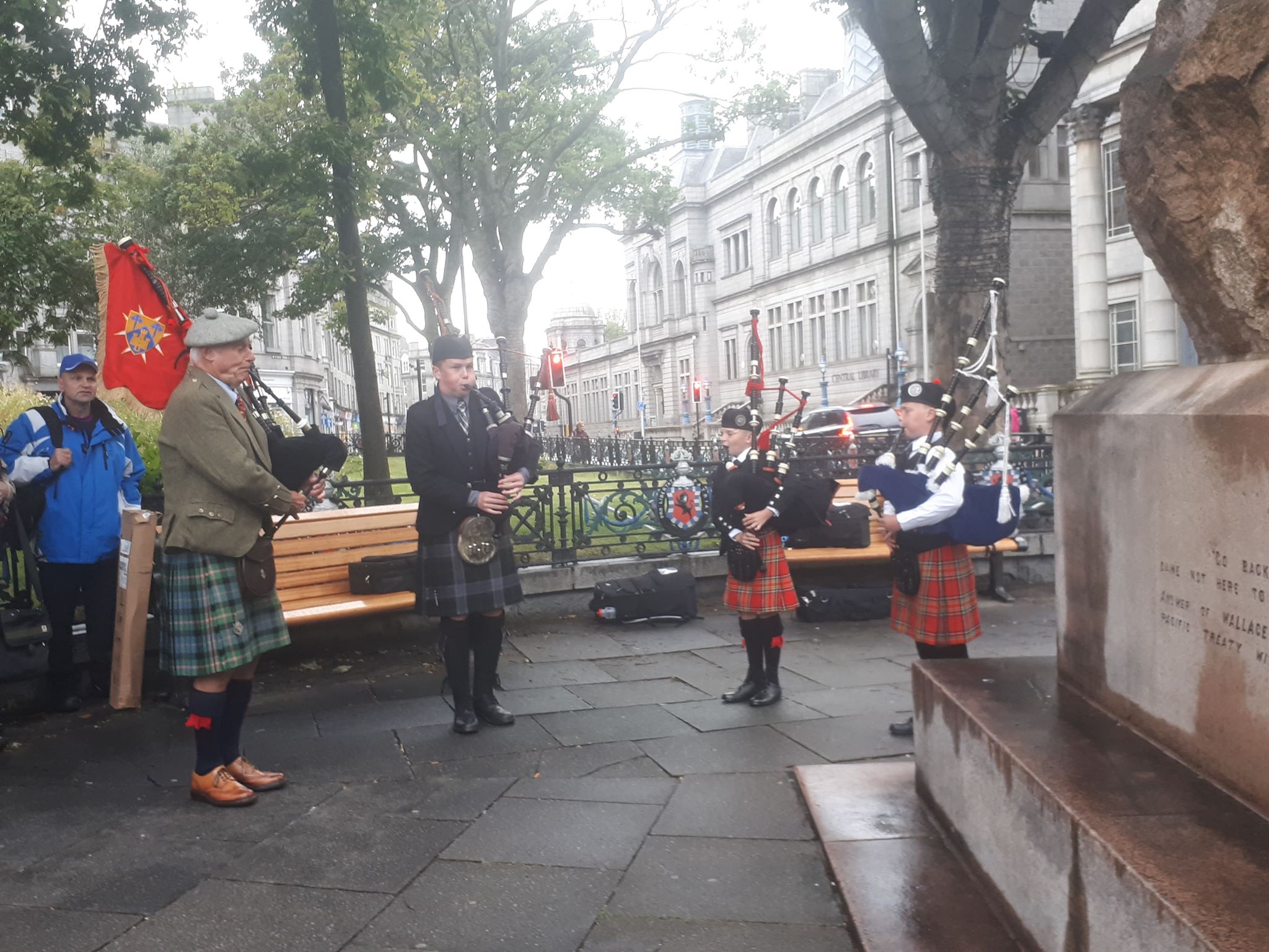 Pipers play at the Wallace statue, Aberdeen.