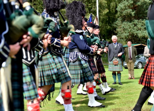 HRH The Duke of Rothesay watches the Lonach Highlanders march by