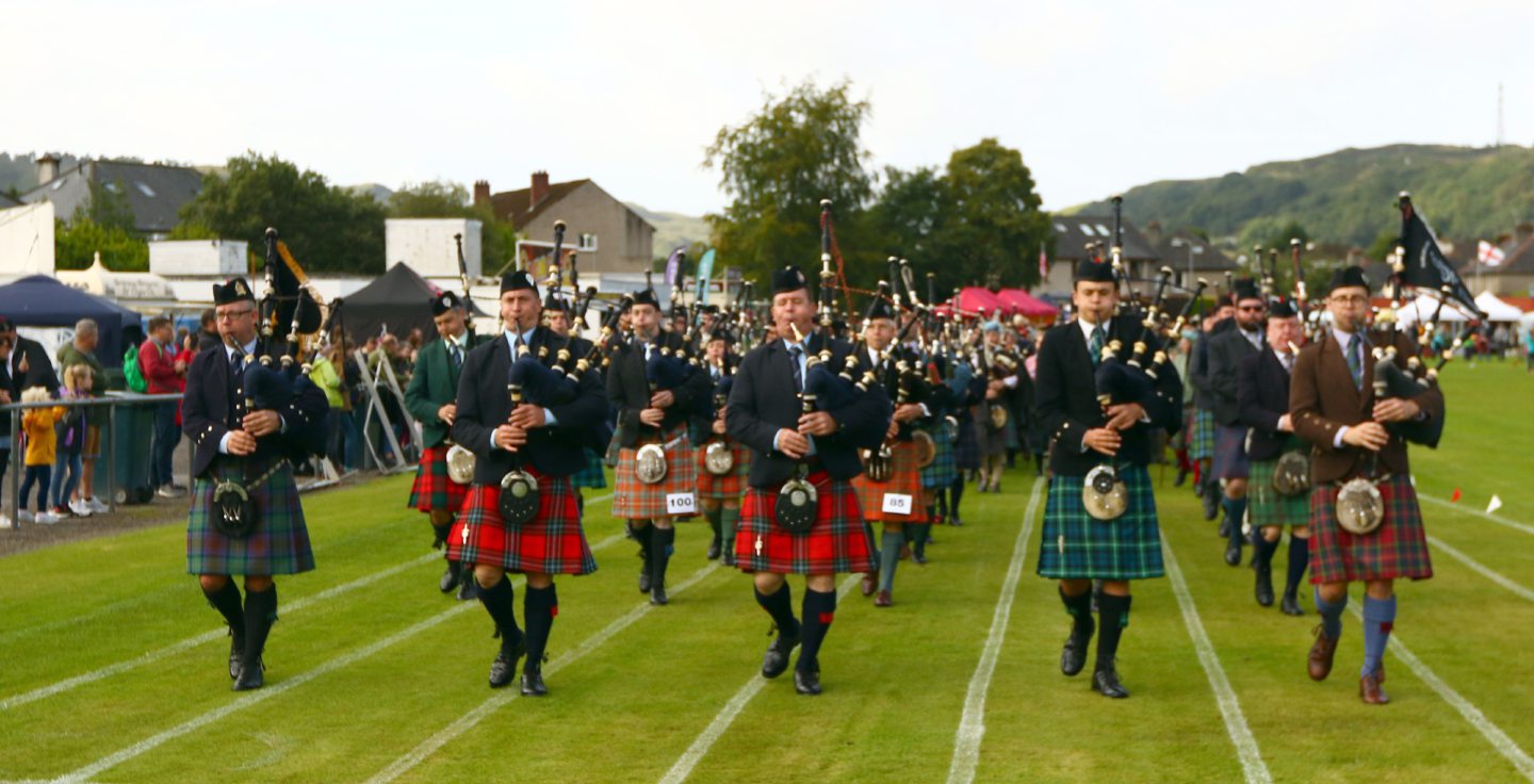 Parade of pipers including the gold and silver medals winners arrive on the games field after marching from Argyll Square in Oban.